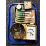 A tray containing cased butter knives, clock keys, desk clocks, mantel clock,