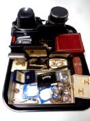 A tray containing assorted wristwatches, costume jewellery, cuff links, crowns,