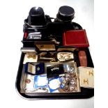 A tray containing assorted wristwatches, costume jewellery, cuff links, crowns,