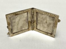 A silver hinged miniature photograph frame