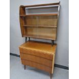 A mid 20th century three drawer chest together with a set of sliding glass bookshelves