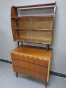 A mid 20th century three drawer chest together with a set of sliding glass bookshelves