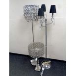 A contemporary table lamp together with two further contemporary floor lamps with glass drops