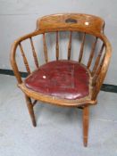 An Edwardian oak captain's armchair