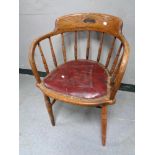 An Edwardian oak captain's armchair