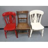 An antique mahogany dining chair together with two further antique painted kitchen chairs