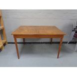 A mid 20th century extending dining table with leaf