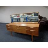 A mid 20th century teak Austin suite six drawer dressing chest on raised legs,