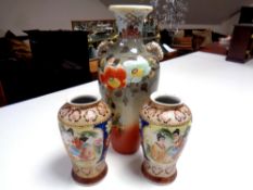 A pair of Japanese vases depicting geishas, height 20.