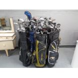Twelve assorted golf bags containing assorted irons, drivers and putters to include Tailor Made,
