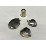 Three silver lockets together with a silver thimble