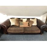 A Tetrad leather and fabric settee with scatter cushions