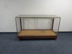 An early 20th century brass framed shop display cabinet