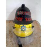 A Royal Air Force fireman's helmet together with a further vintage fireman's helmet