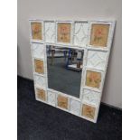 A rectangular bevelled mirror in painted frame