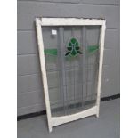 An antique stained glass leaded sash window in frame