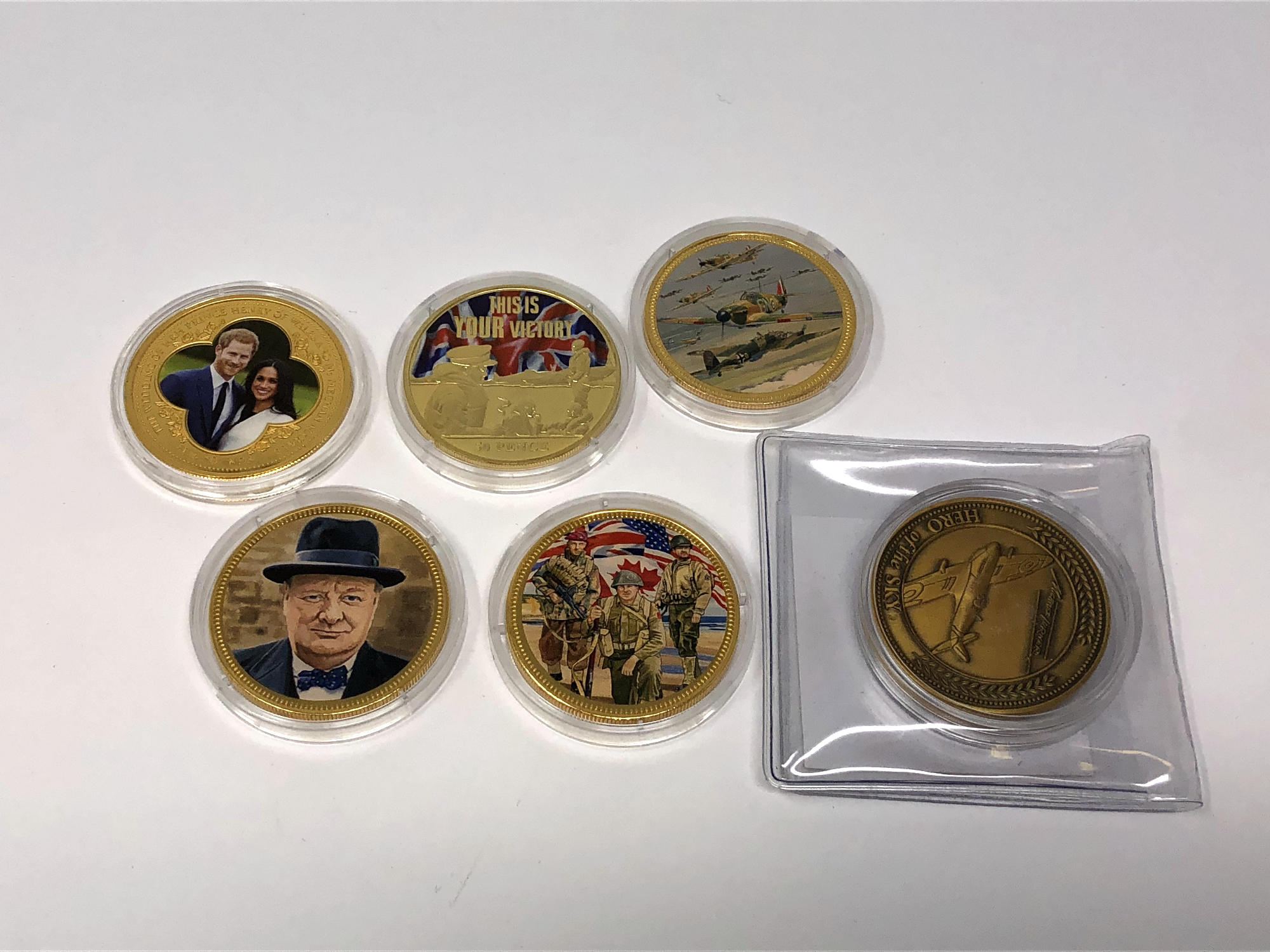 Six various commemorative coins relating to D-Day, Churchill, Prince Harry and Meghan Markle etc.