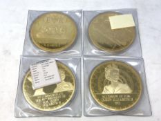 Four large Queen Elizabeth II Commemorative Coins, each 10cm diameter, each 376g.