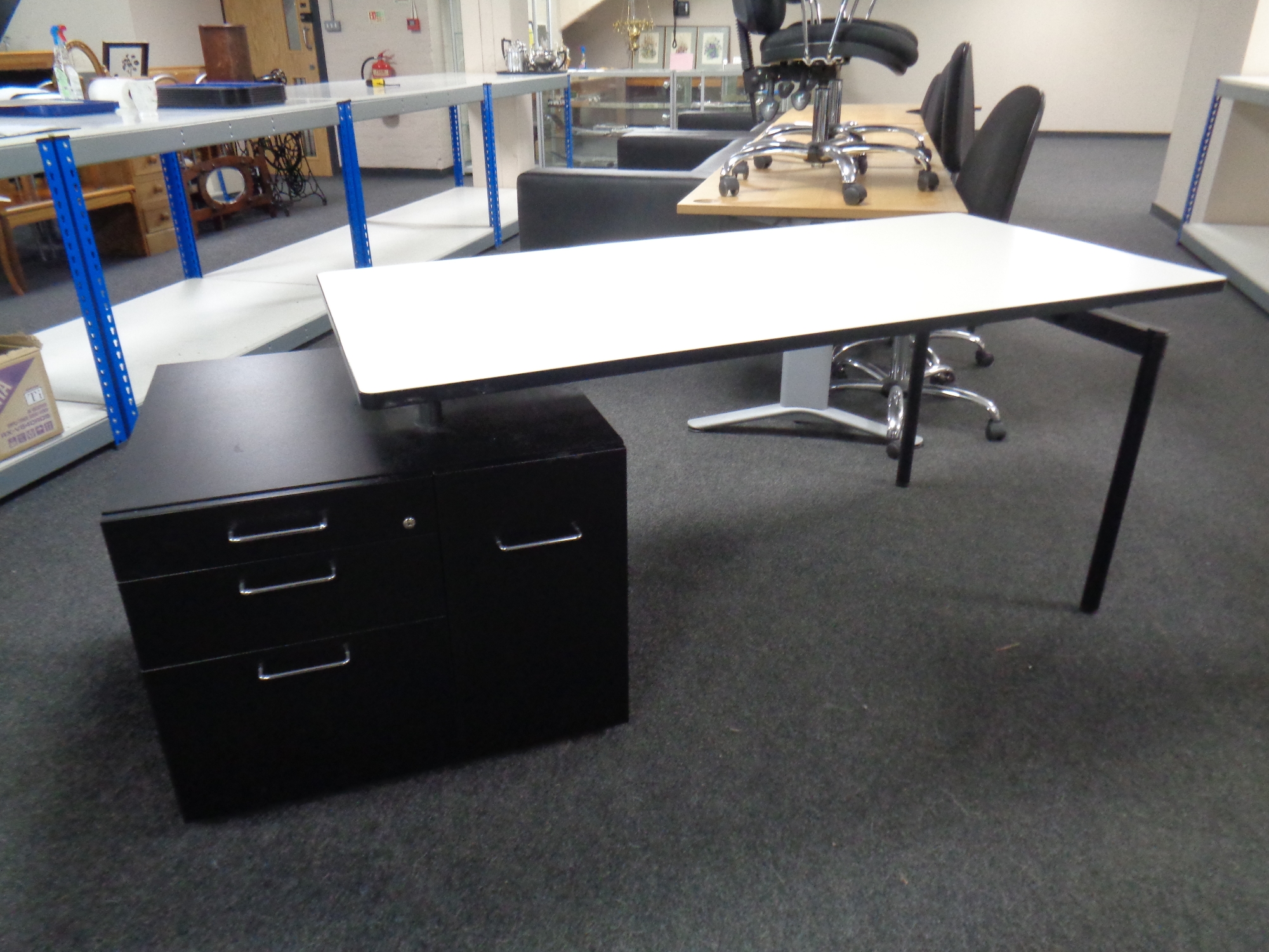A contemporary grey office table fitted with three drawer chest and cabinet,