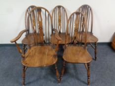 A set of five Windsor kitchen stick back chairs comprising of one carver,