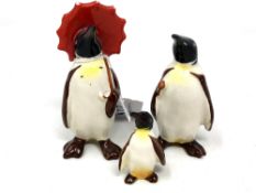 A Beswick china figure : Penguin (With Umbrella), model 802, black and white with yellow and red,