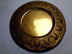 An antique brass embossed plaque