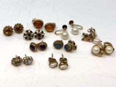 Ten pairs of gold earrings with studs including opal, amethyst, citrine, sapphire,