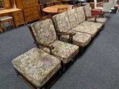 An Ercol wood framed four piece lounge suite comprising of three seater settee,