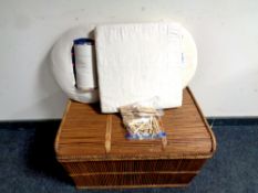 A wicker hamper containing lace making equipment