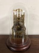 A brass skeleton cathedral clock under glass dome with key