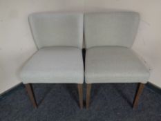 A pair of contemporary bedroom chairs upholstered in a grey fabric