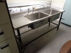 A commercial stainless steel double sink unit with drainer and taps, width 182 cm, depth 65.