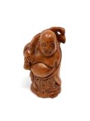 A Japanese carved hardwood netsuke : Pot-Bellied Man.