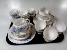 A tray containing two 21 piece bone china tea services,