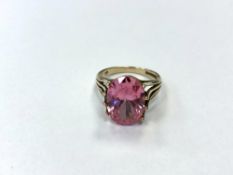 A 9ct yellow gold vibrant pink dress ring, probably synthetic sapphire, size N, 5.2g.