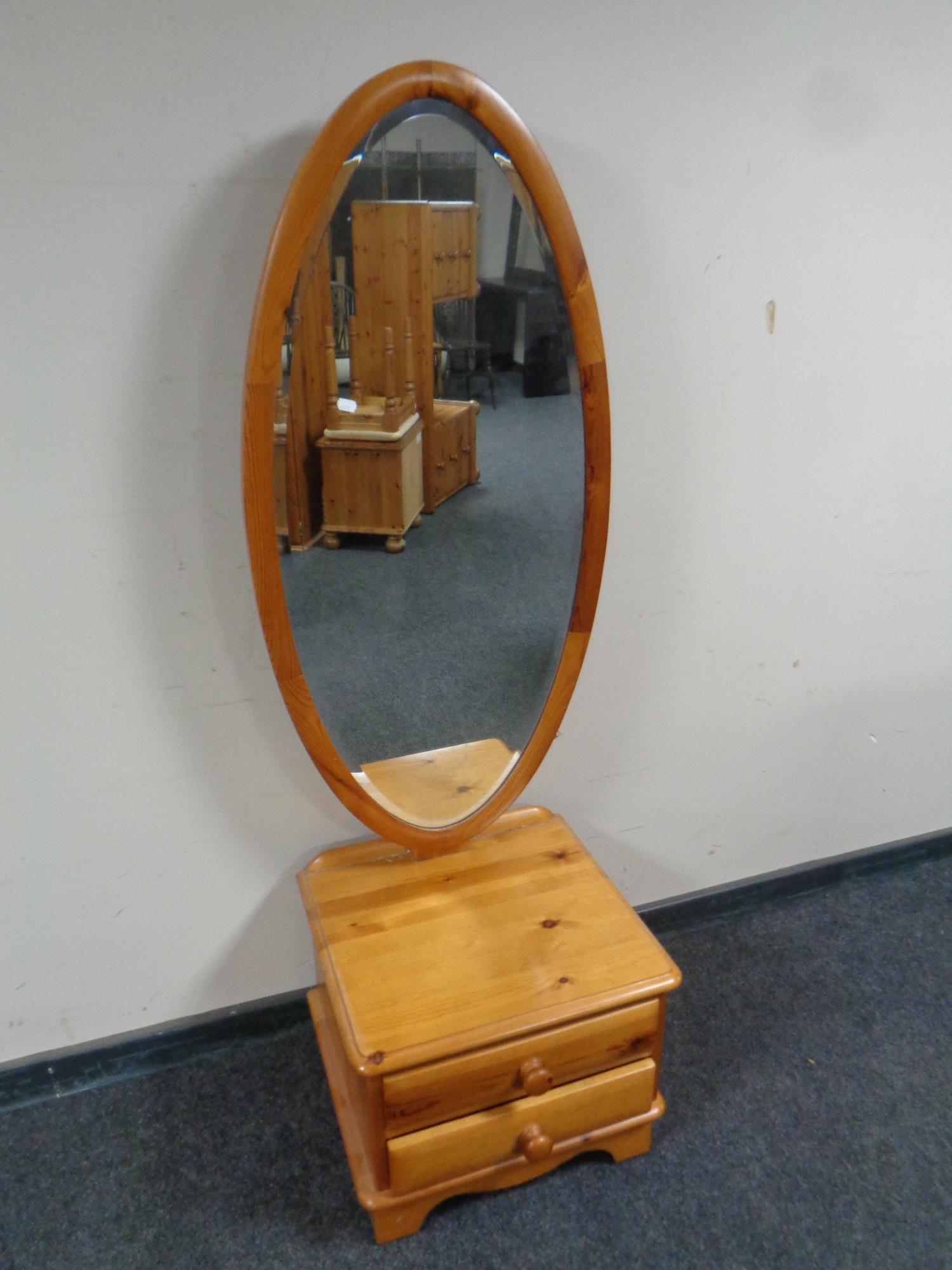 A contemporary pine cheval mirror fitted two drawers