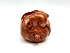 A Japanese carved hardwood netsuke : Rats on Fruit.