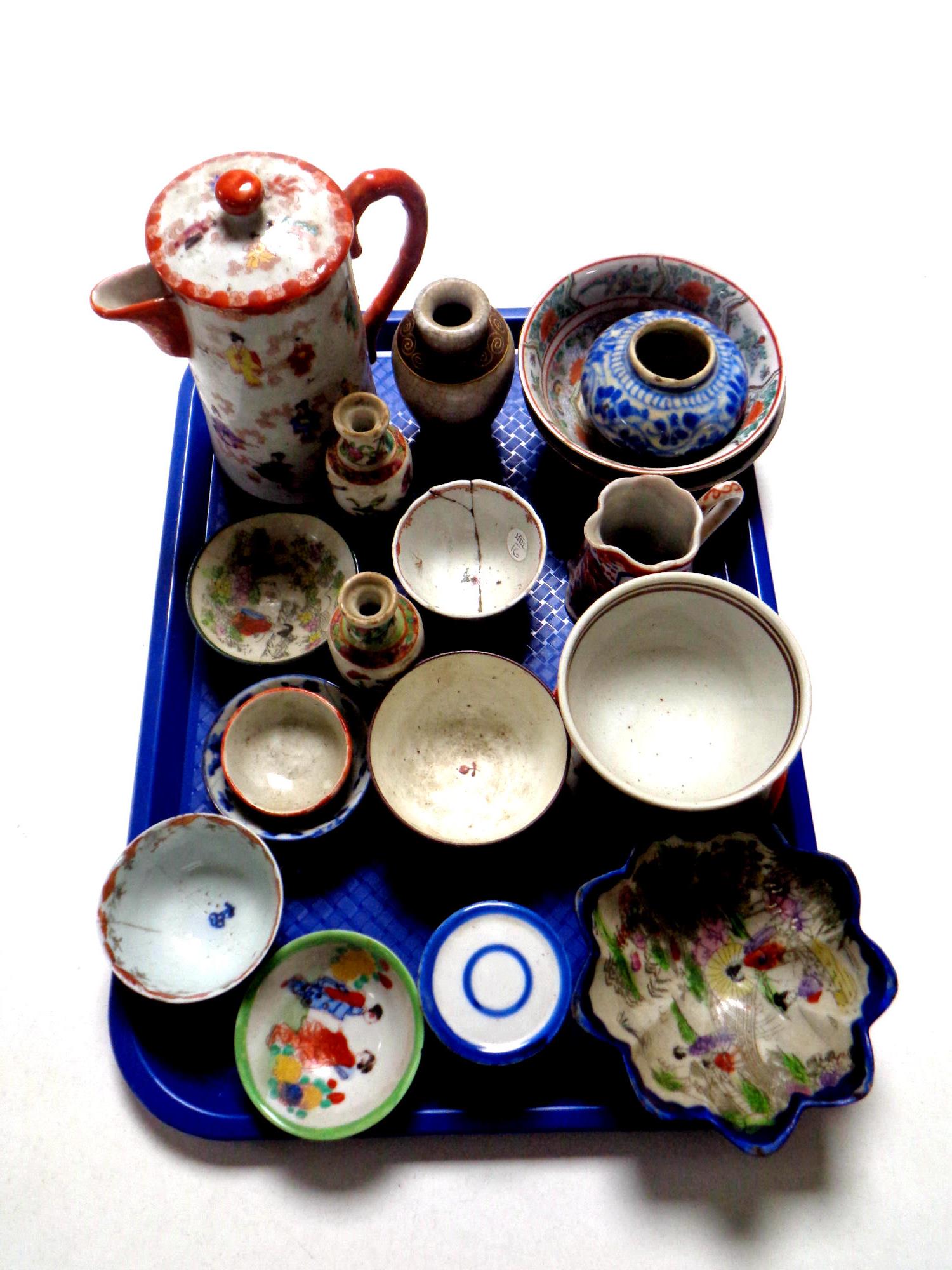A tray containing a quantity of antique oriental wares to include teapot, tea bowls,