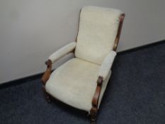 A 19th century inlaid mahogany framed armchair upholstered in a beige fabric