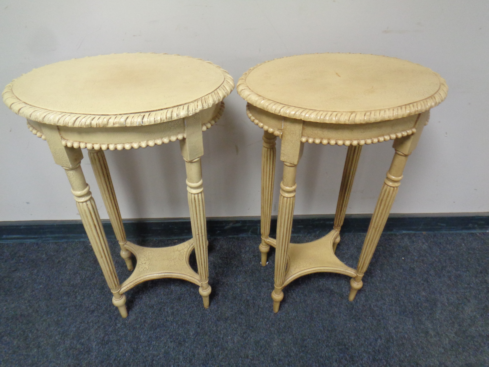 A pair of contemporary French style oval lamp tables on reeded legs,
