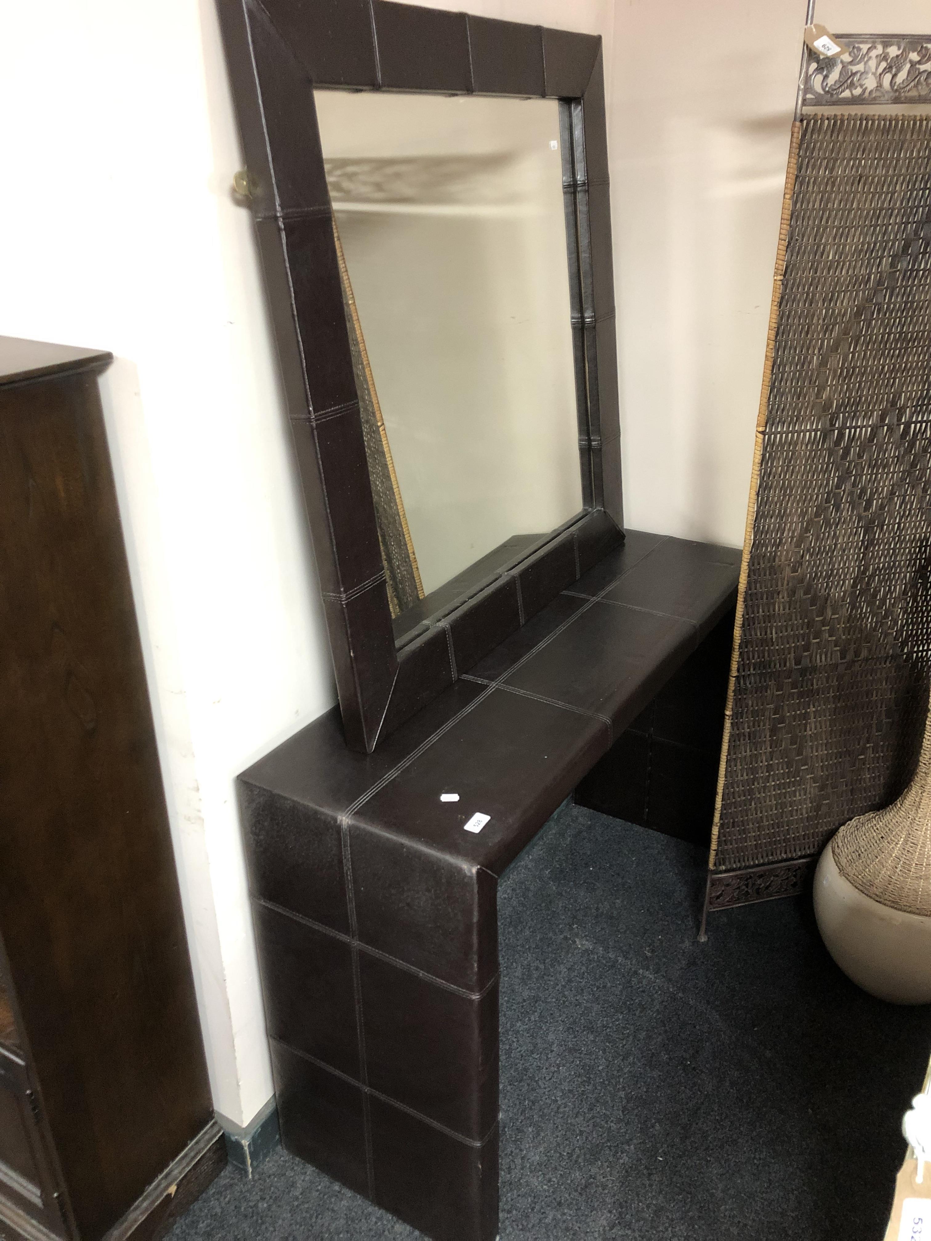 A contemporary brown leather hall table and mirror, table width 125 cm,