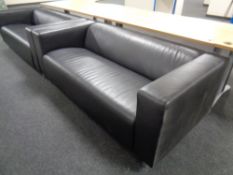 A pair of black leather reception settees,