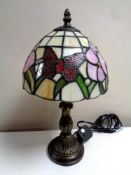 A Tiffany style table lamp with leaded glass butterfly shade