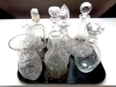 A tray containing antique and later cut glass decanters together with a cut glass vase