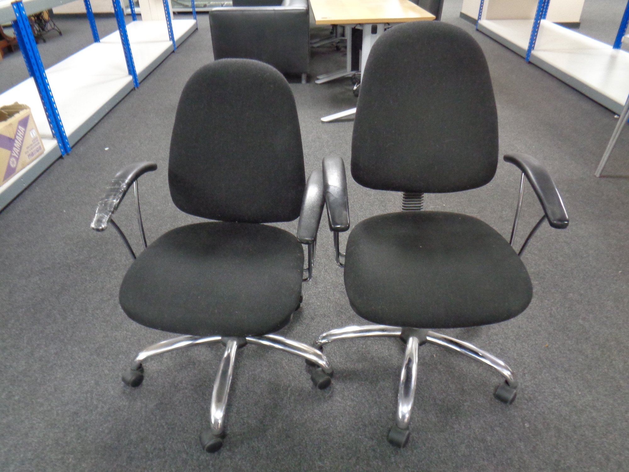 A pair of adjustable swivel office armchairs