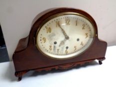 An Edwardian mahogany cased mantel clock with an oval silvered dial