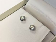 A pair of 18ct white gold diamond solitaire earrings,