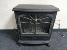 An electric heater in the form of a stove