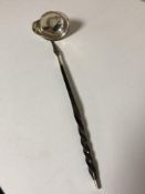 A silver toddy ladle inset with a coin