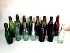 A box containing a quantity of vintage glass brewery bottles bearing advertisement